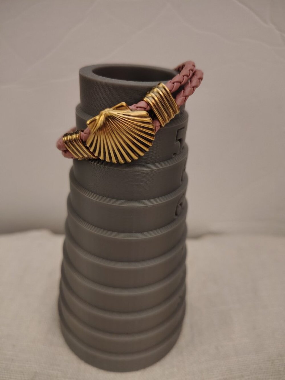 Pink braided leather bracelet with center gold tone scallop shell